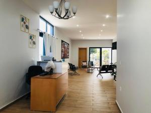 an office with a desk and chairs in a room at Edificio Cosec Hotel in Cova Figueira