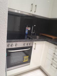 a kitchen with a stove and a sink at Ferienwohnung/Montagewohnung 2 in Bad Driburg