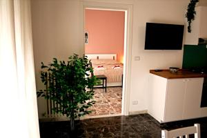 a bedroom with a bed and a potted plant at Dimore Demetra in Canosa di Puglia