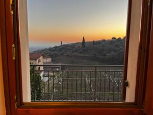 a view of a sunset from a window at "IL VIGNETO" Apartment in Negrar