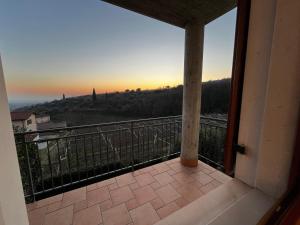 a balcony with a view of the sunset at "IL VIGNETO" Apartment in Negrar