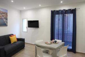 a living room with a table and a couch at Casa Lu Mari in Sciacca