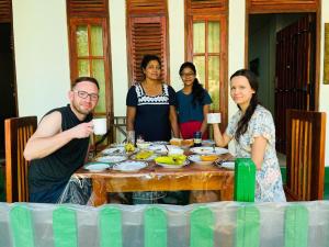 a group of people standing around a table at Jm Resort in Dambulla