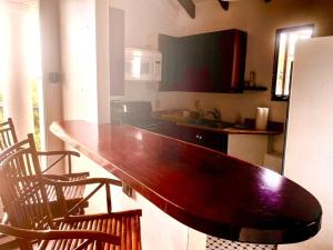 a kitchen with a large wooden table and chairs at Captains Quarters at Lowry Hill in Christiansted