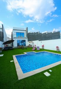 a house with a swimming pool in the yard at Al Bandar Luxury Villa with 5BHK with private pool in Fujairah