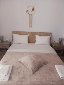 a large bed with two pillows on top of it at Makarios Apartment Near Athens Aiport in Spáta