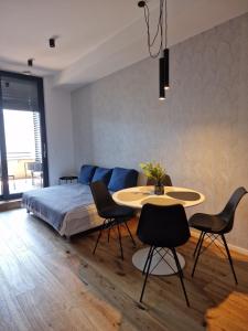 a bedroom with a bed and a table and chairs at Apartment Anya in Koper