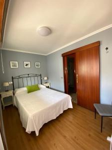 a bedroom with a large bed and a wooden floor at CASA DA REGUEIRA in Redondela
