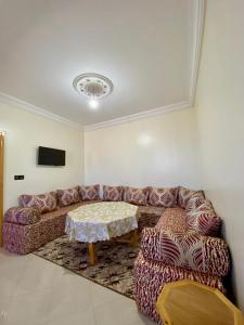 a living room with a couch and a table at La casa wadie 3 in Sidi Ifni