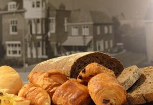 a pile of bread and pastries sitting on a table at Hotel Restaurant Piccard in Vlissingen
