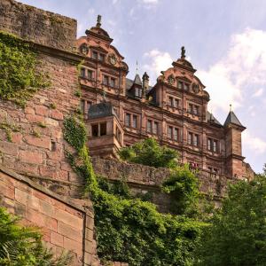 a large brick building on top of a brick wall at Ferien im Odenwald Zur Schmiede in Schönbrunn