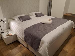 a bedroom with a large bed with two pillows at Apartment Anya in Koper