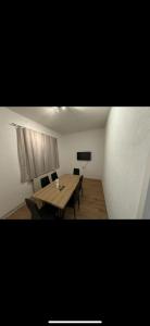 a room with a table and chairs and a television at 3 Schlafzimmer Apartment in Euratsfeld
