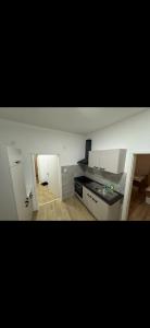 a kitchen with white cabinets and a stove top oven at 3 Schlafzimmer Apartment in Euratsfeld