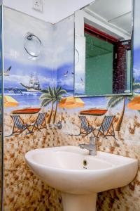 a bathroom with a sink and a mirror at Villa Ravichini in Polonnaruwa