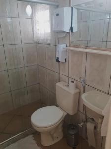 a small bathroom with a toilet and a sink at Pousada Inn Engenho do Sonho in Rio das Ostras
