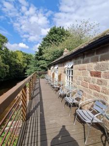 a row of chairs sitting on a wooden deck at Georgia Lodge in Knaresborough