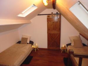a attic room with a bed and a barn door at Augettes Bergerie in Saint-Hymer +23 photos