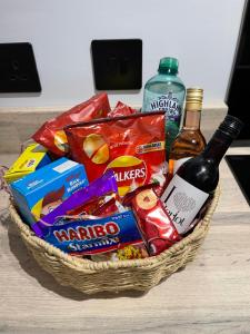 a basket of snacks and a bottle of wine at 1bedroom ground floor apartment in Aberdeen