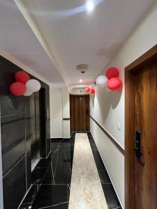a hallway with red and white balloons on the wall at Hotel Imperial in Mumbai