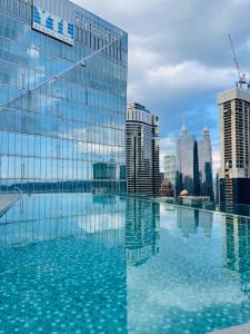 a large swimming pool on the roof of a building at Crystal Suite at Dorsett Bukit Bintang KL in Kuala Lumpur