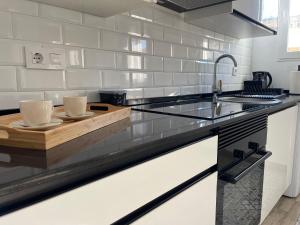 a kitchen with a counter with two cups on it at Apartamento El Castell in Alaquas