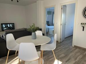 a living room with a white table and white chairs at Apartamento El Castell in Alaquas