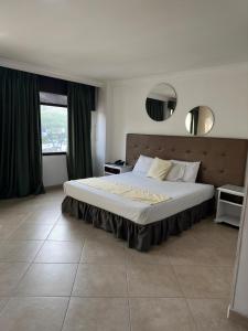 Un dormitorio con una cama grande y una ventana en Hotel Prince Plaza, en Medellín