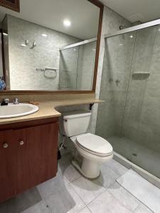 a bathroom with a toilet and a sink and a shower at Hotel Prince Plaza in Medellín