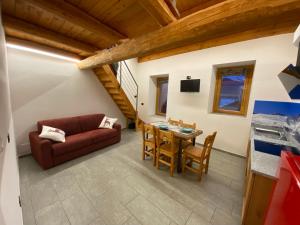 a living room with a couch and a table at BAITA GHITIN in Ostana