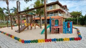a playground in front of a house at No mar, condomínio pé na areia in Florianópolis