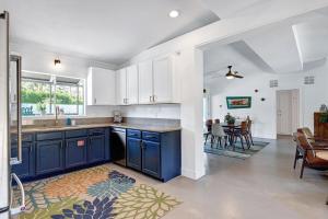 a kitchen with blue cabinets and a dining room at Shelby Sands in Palm Springs