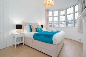 a white bedroom with a bed and a window at 4 Bed House - Lots of Parking - Garden - Fast WIFI - Groups - Contractors - Excelled Value Accommodation - 802W in Birmingham