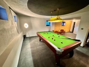 a pool table in a living room with at Willa Czaremka in Ujsoły