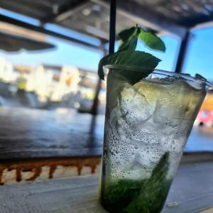 a drink with a green leaf on a table at B&B L' Oasi in Chiatona