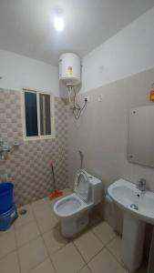 a bathroom with a toilet and a sink at Entire 1 BHK Cottage in Nainital