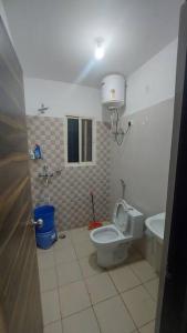 a bathroom with a toilet and a sink at Entire 1 BHK Cottage in Nainital