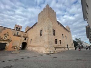 a large building with a tower on the side of it at Apartamento El Castell in Alaquas
