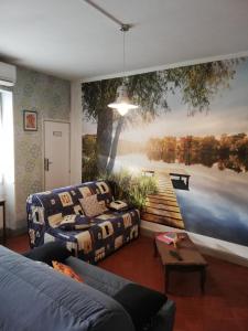 a living room with a large painting on the wall at CHEZ FERNAND in Arles-sur-Tech