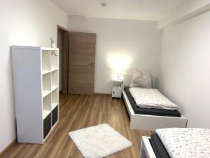 a bedroom with two beds and a closet at Ferienwohnung in Oberahr in Oberahr