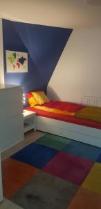 a bedroom with a bed and a colorful rug at STUDIO SLOW CERLA 9 Korbielów in Korbielów