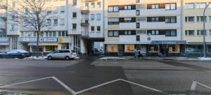 an empty city street with a white car parked in front of buildings at 250m Rhein - ruhig - Hbf - Boxspringbett - K-111-S in Koblenz