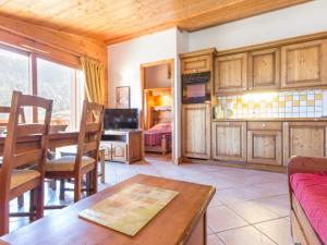 a living room with a table and a dining room at Appartement Les Arcs 1800, 4 pièces, 7 personnes - FR-1-346-334 in Arc 1800