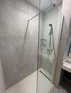 a shower with a glass door in a bathroom at New Gudauri Redco Premium Apartments in Gudauri