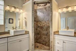 a bathroom with two sinks and a shower at Crane's Landing at Pirates Bay in Port Aransas