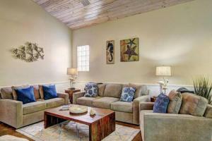 a living room with two couches and a coffee table at Crane's Landing at Pirates Bay in Port Aransas