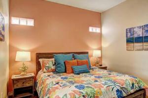 a bedroom with a bed with colorful pillows at Crane's Landing at Pirates Bay in Port Aransas