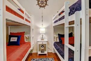 a bedroom with two bunk beds and a fireplace at Crane's Landing at Pirates Bay in Port Aransas
