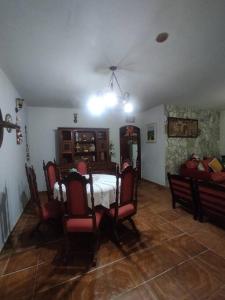 a dining room with a table and chairs at Sítio Nosso Cantinho in Mogi das Cruzes +12 photos