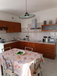 a kitchen with a table with a plate on it at Villa Pia in Casalgrasso +5 photos